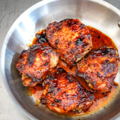 glazed honey garlic chicken thighs in a skillet