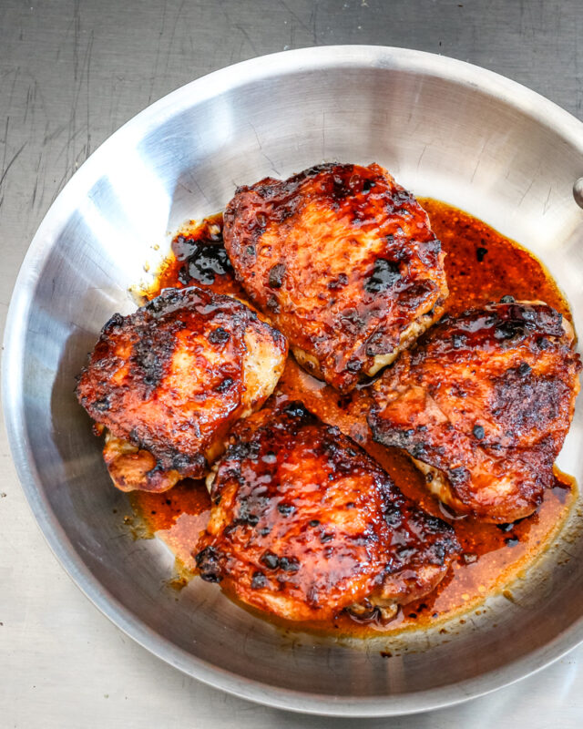 glazed honey garlic chicken thighs in a skillet
