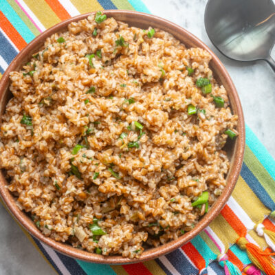 Instant Pot bulgur pilaf in a serving bowl with green onions.