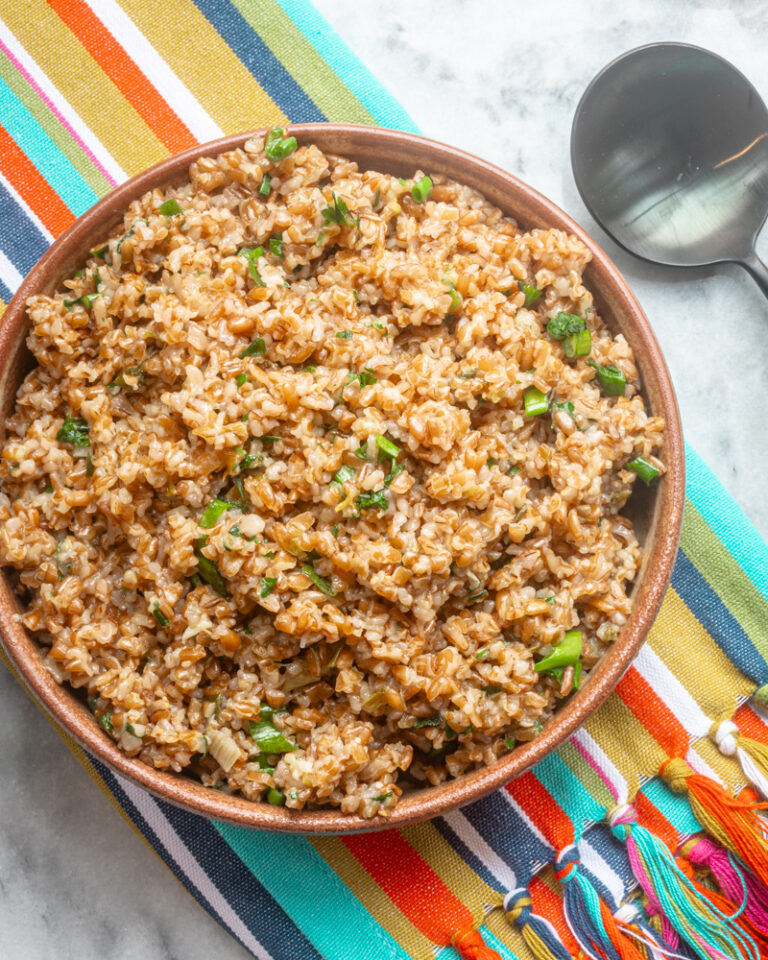 Instant Pot bulgur pilaf in a serving bowl with green onions.