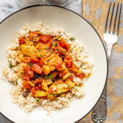 Country captain chicken in a bowl with rice.