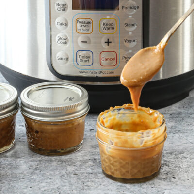 Instant Pot dulce de leche in jars for storage.