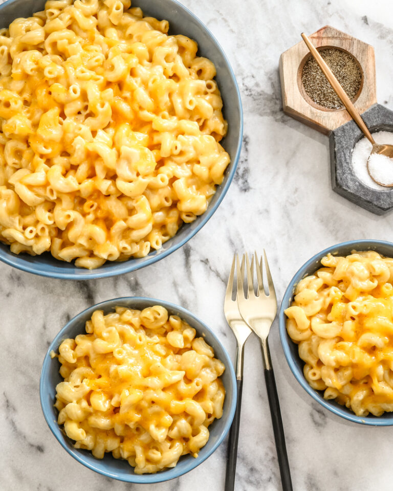 Instant Pot macaroni and cheese in bowls with forks on the side.