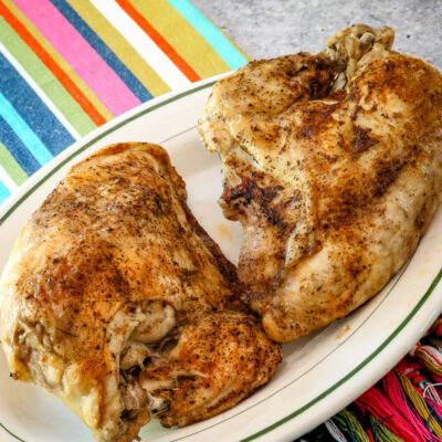 Instant Pot split chicken breasts on a small serving platter.