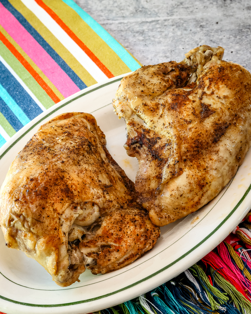 Instant Pot split chicken breasts on a small serving platter.