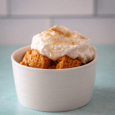Sweet potato pudding topped with whipped cream and cinnamon.