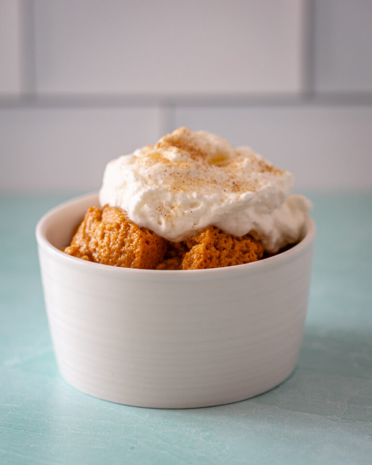 Sweet potato pudding topped with whipped cream and cinnamon.