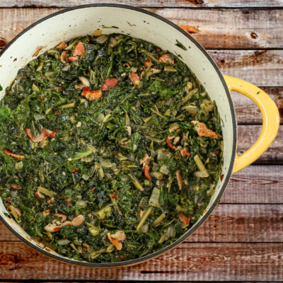 dutch oven with a mess of kale and mustard greens with bacon