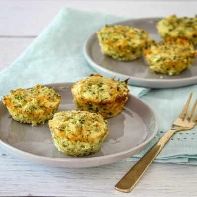 keto broccoli bites on serving plates with appetizer forks.