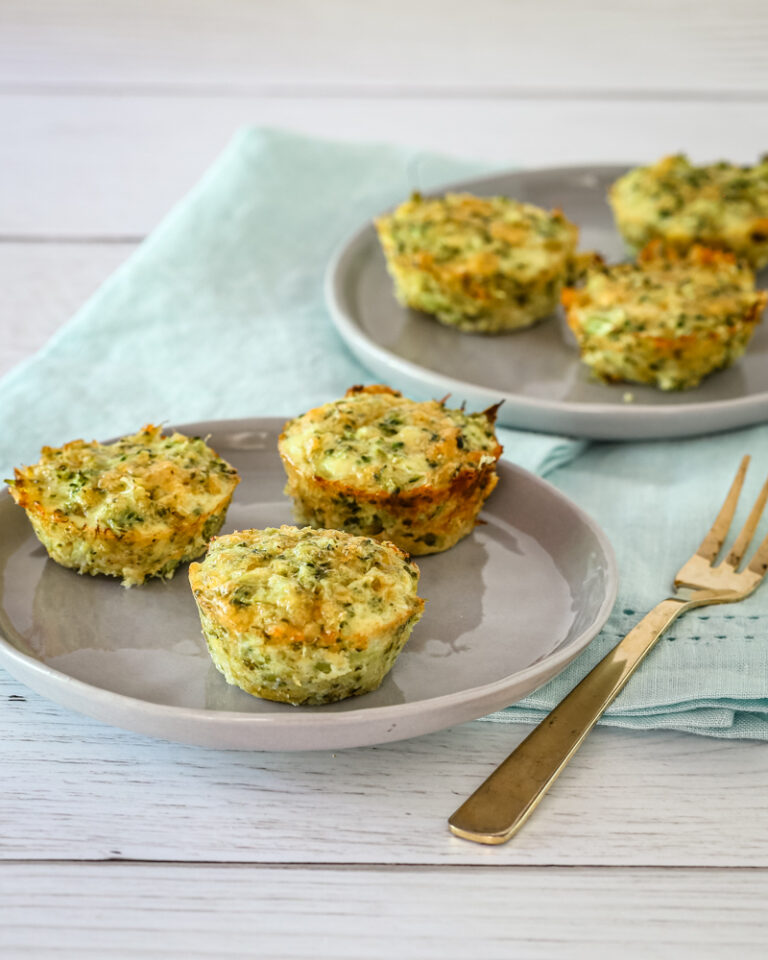 keto broccoli bites on serving plates with appetizer forks.