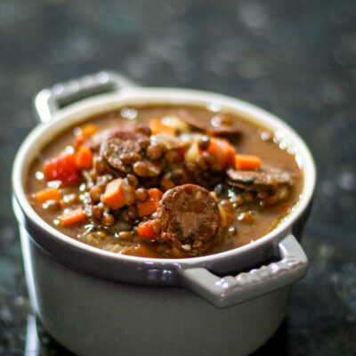 lentil and sausage soup in a small bowl