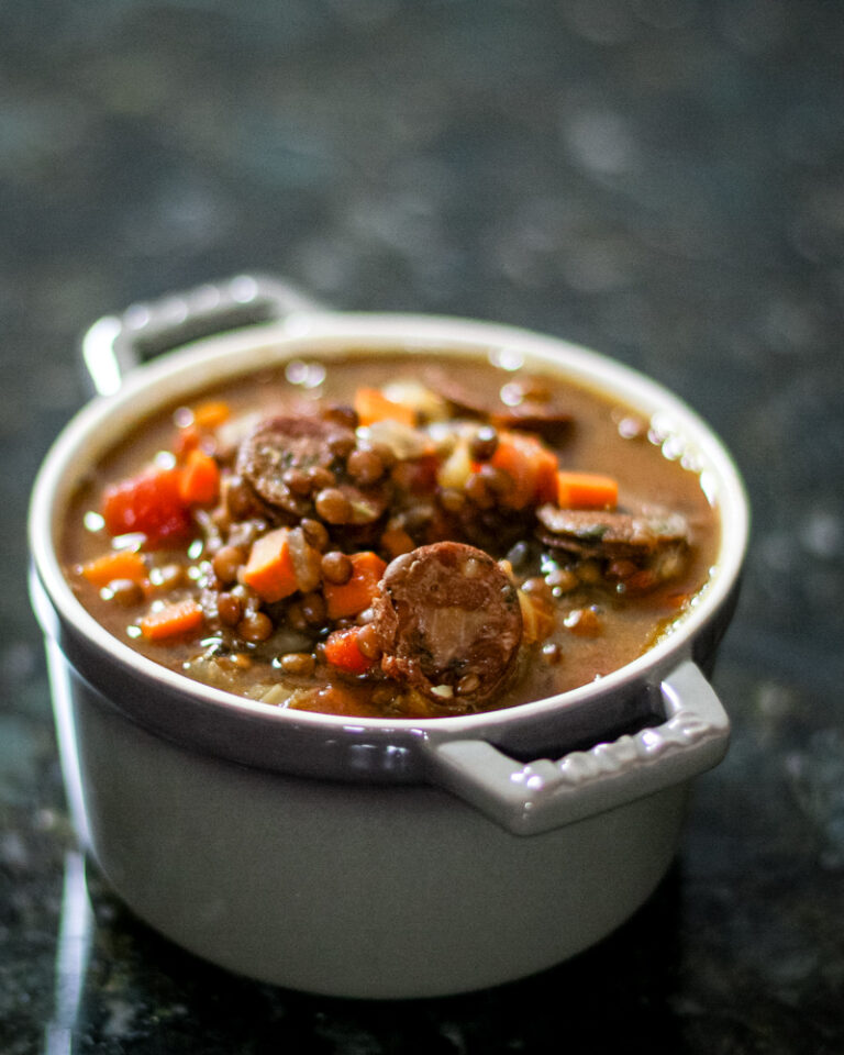 lentil and sausage soup in a small bowl