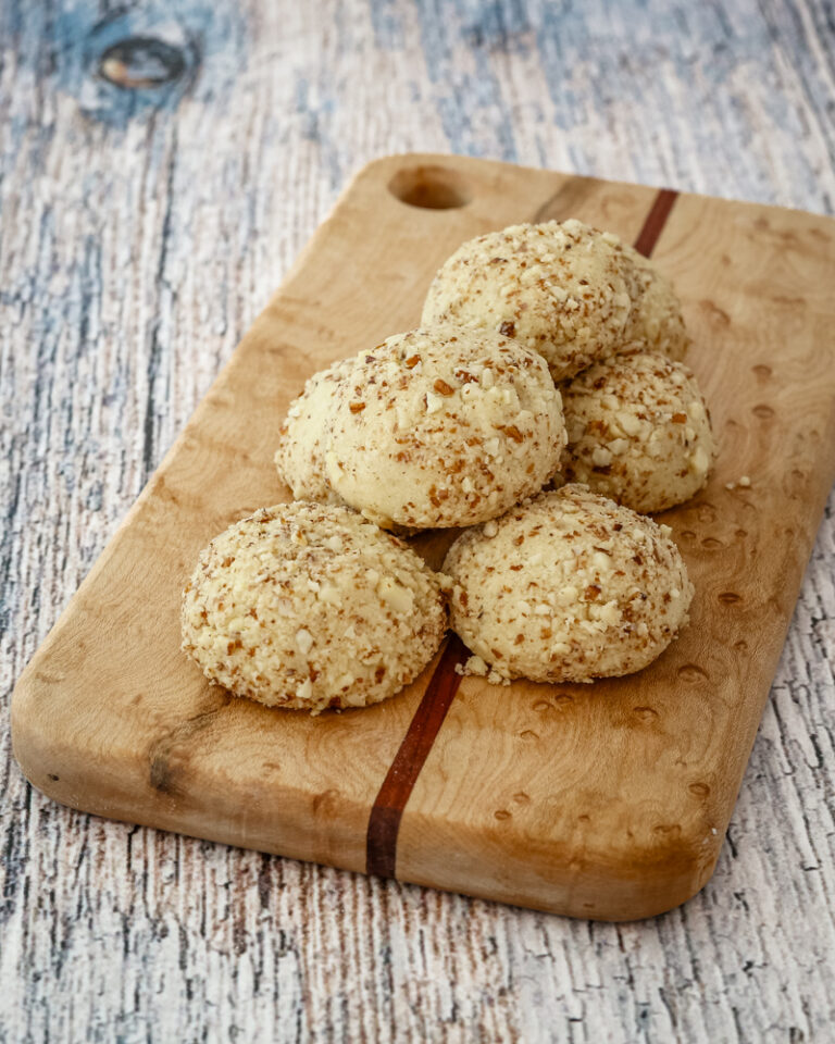 macadamia nut cookies on a small cutting board