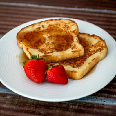 maple cinnamon french toast on a plate with strawberries