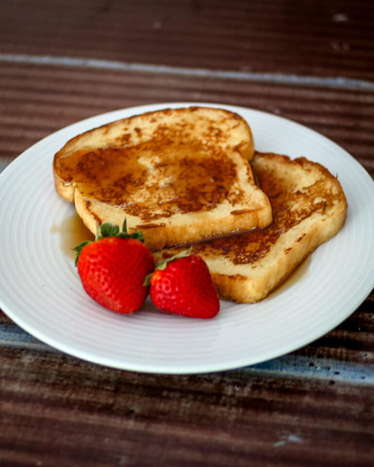 maple cinnamon french toast on a plate with strawberries