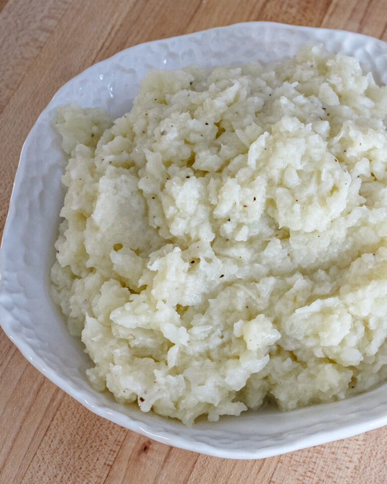 A serving bowl of mashed cauliflower