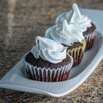 Moist chocolate cupcakes on a serving tray.