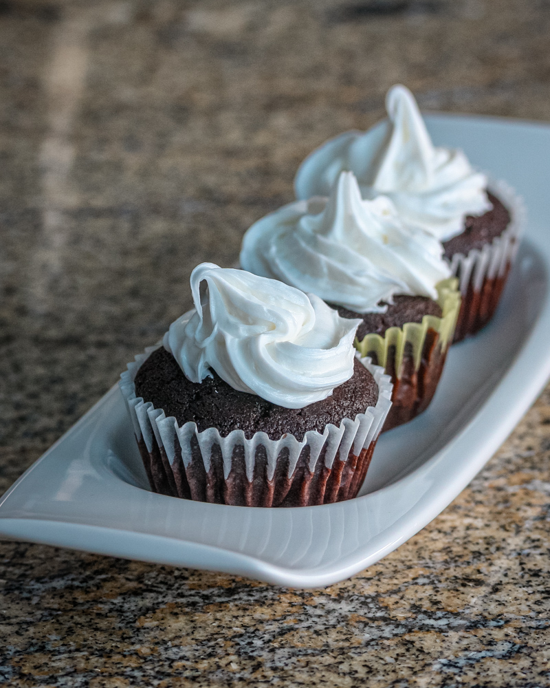 Moist chocolate cupcakes on a serving tray.