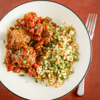 moroccan meatballs on a plate with couscous