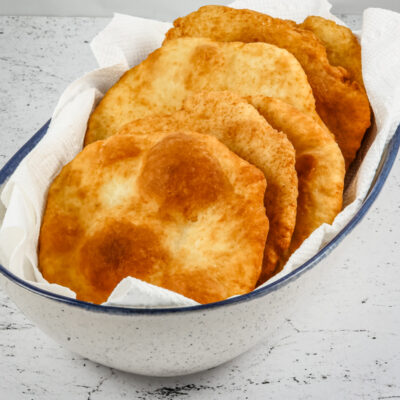 Native American fry bread in a serving bowl with paper towels.