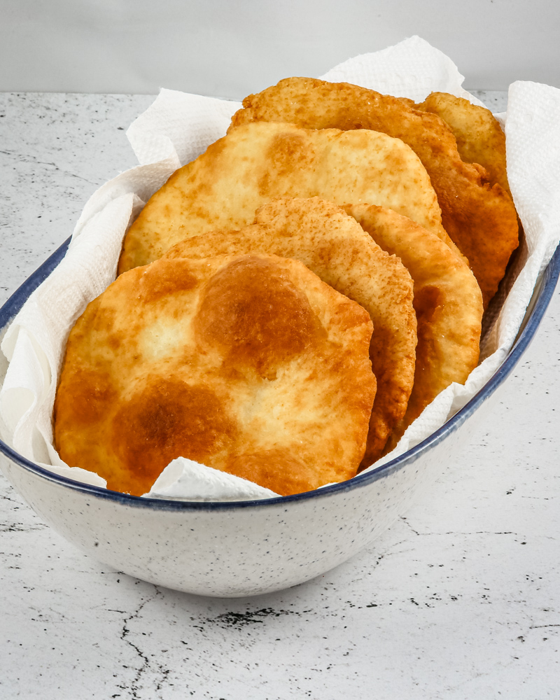 Native American fry bread in a serving bowl with paper towels.