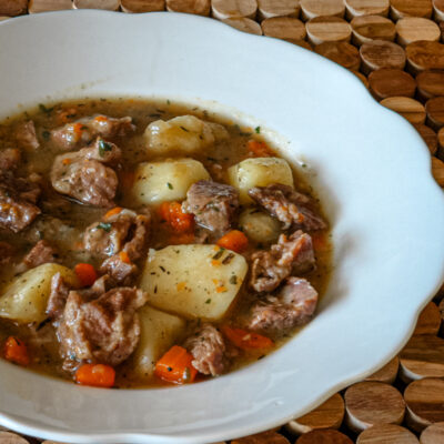 A bowl of old-fashioned beef stew with vegetables.