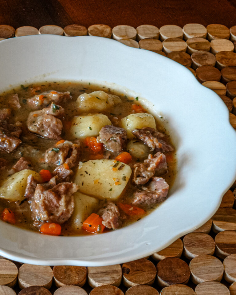 A bowl of old-fashioned beef stew with vegetables.