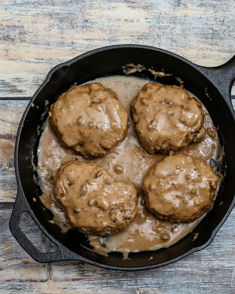 Overhead photo of hamburger steaks with gravy.