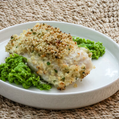 pea puree on a plate with a halibut filet