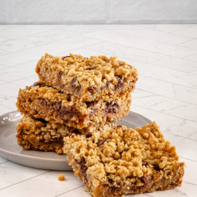 A stack of chewy peanut butter chocolate chip oat bars.