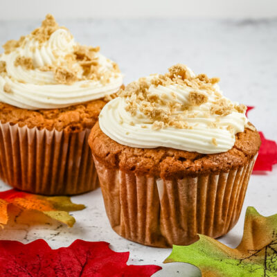 Freshly baked peanut butter cupcakes with creamy frosting and crumbled topping.