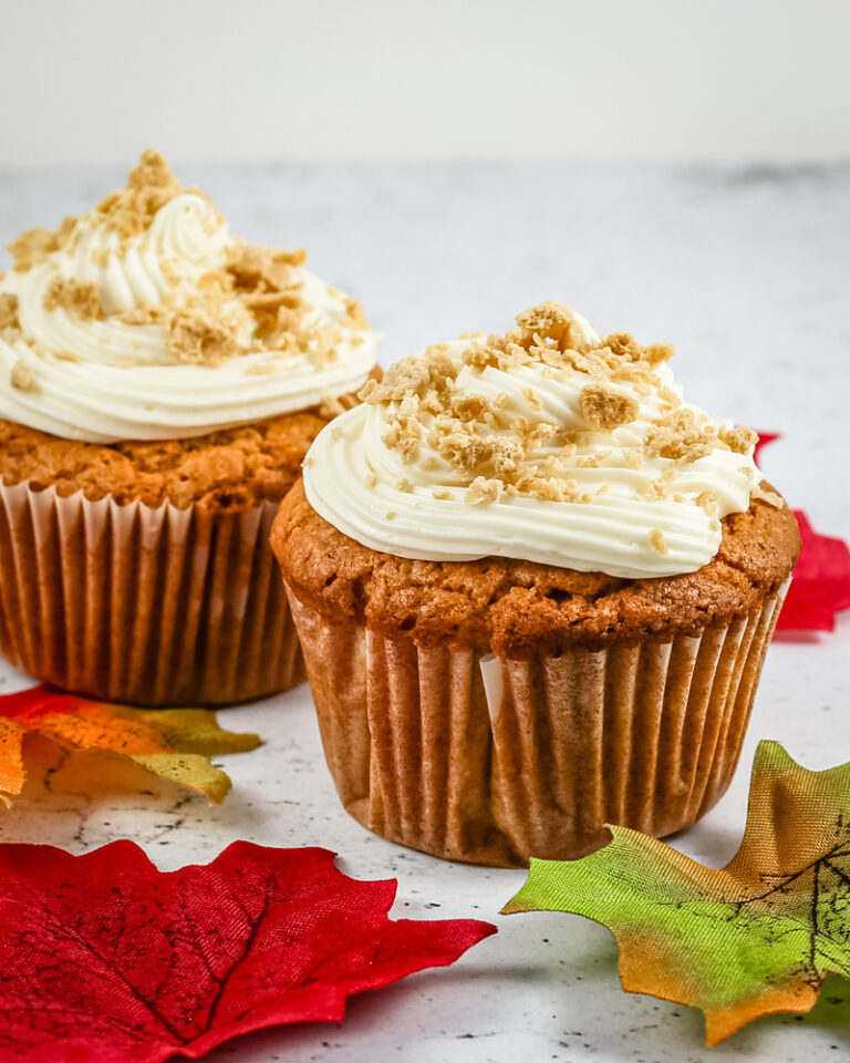 Freshly baked peanut butter cupcakes with creamy frosting and crumbled topping.