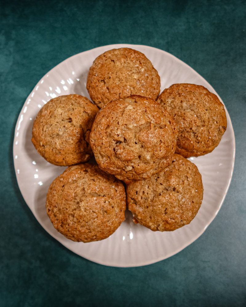 Pear muffins on a plate with more in the background