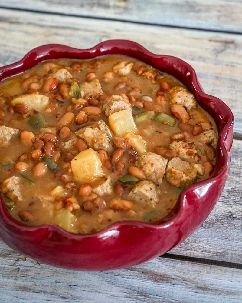 slow cooker pineapple beans with sausage in a serving dish