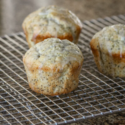 poppy seed muffins, glazed, on a cooling rack