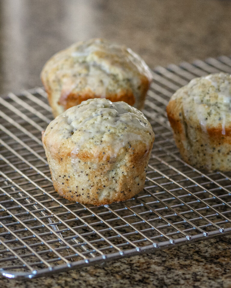poppy seed muffins, glazed, on a cooling rack