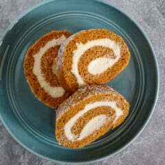 Slices of pumpkin cake roll with cream cheese filling.