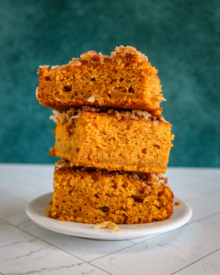 Pumpkin cake with broiled coconut pecan topping, stacked on a plate