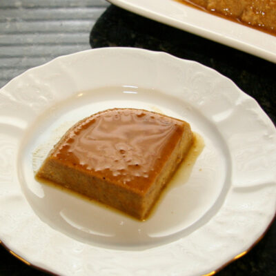 A slice of pumpkin flan on a dessert plate