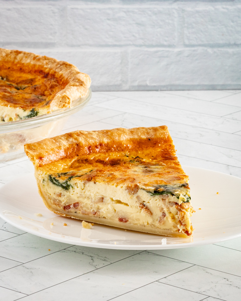 A slice of quiche lorraine on a plate