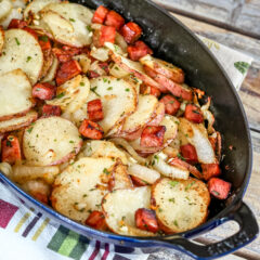 Roasted potatoes and ham in a baking dish.