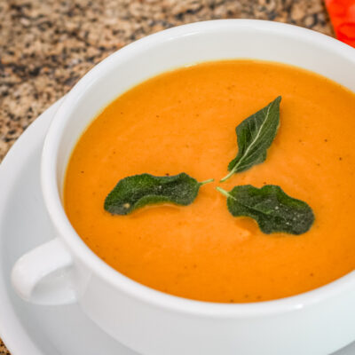 Creamy pumpkin soup with swirls of spice on top.