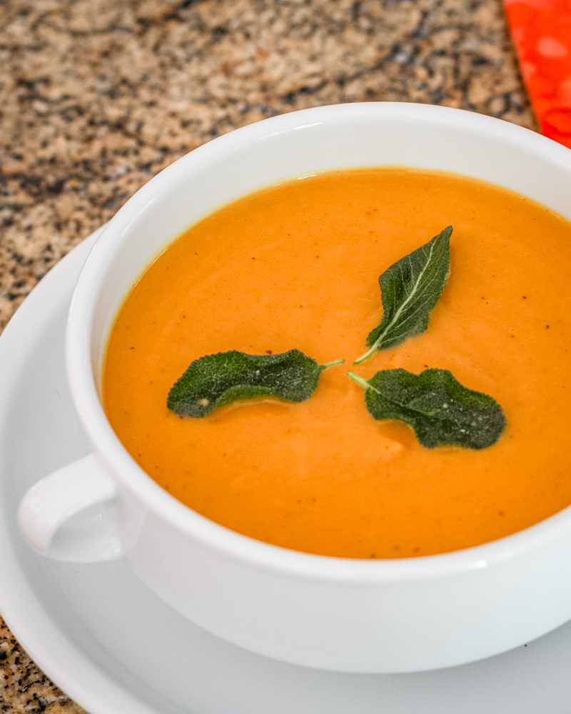 Creamy pumpkin soup with swirls of spice on top.