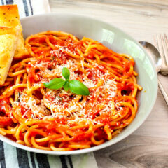 roasted tomato sauce in a serving bowl with basil garnish.