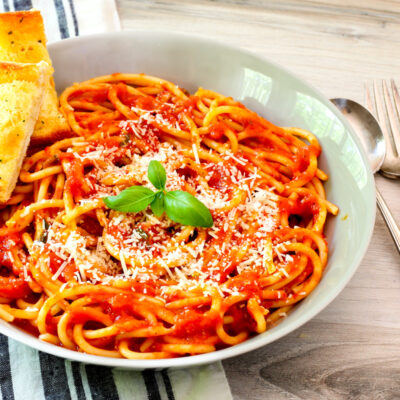 roasted tomato sauce in a serving bowl with basil garnish.