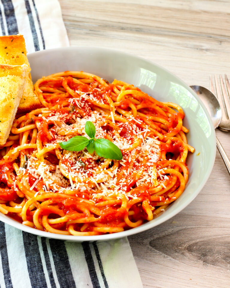 roasted tomato sauce in a serving bowl with basil garnish.