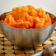Creamy mashed sweet potatoes served in a metal bowl.