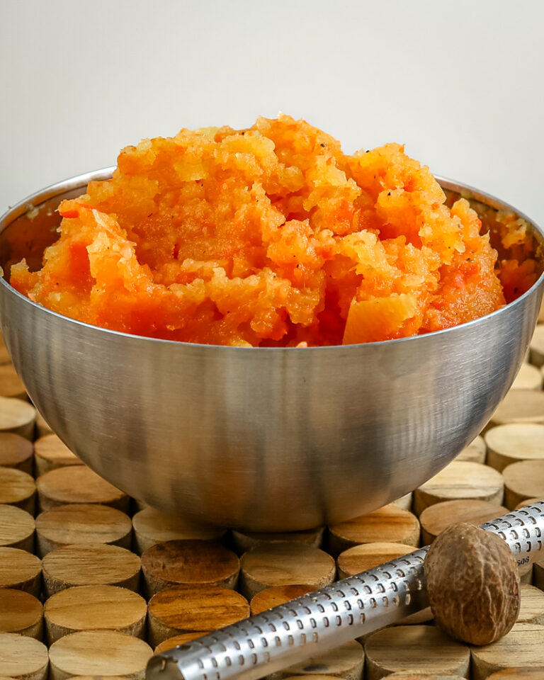 Creamy mashed sweet potatoes served in a metal bowl.