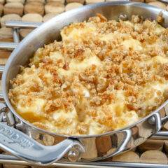 A baking dish with rutabaga gratin with breadcrumb topping and cheese.