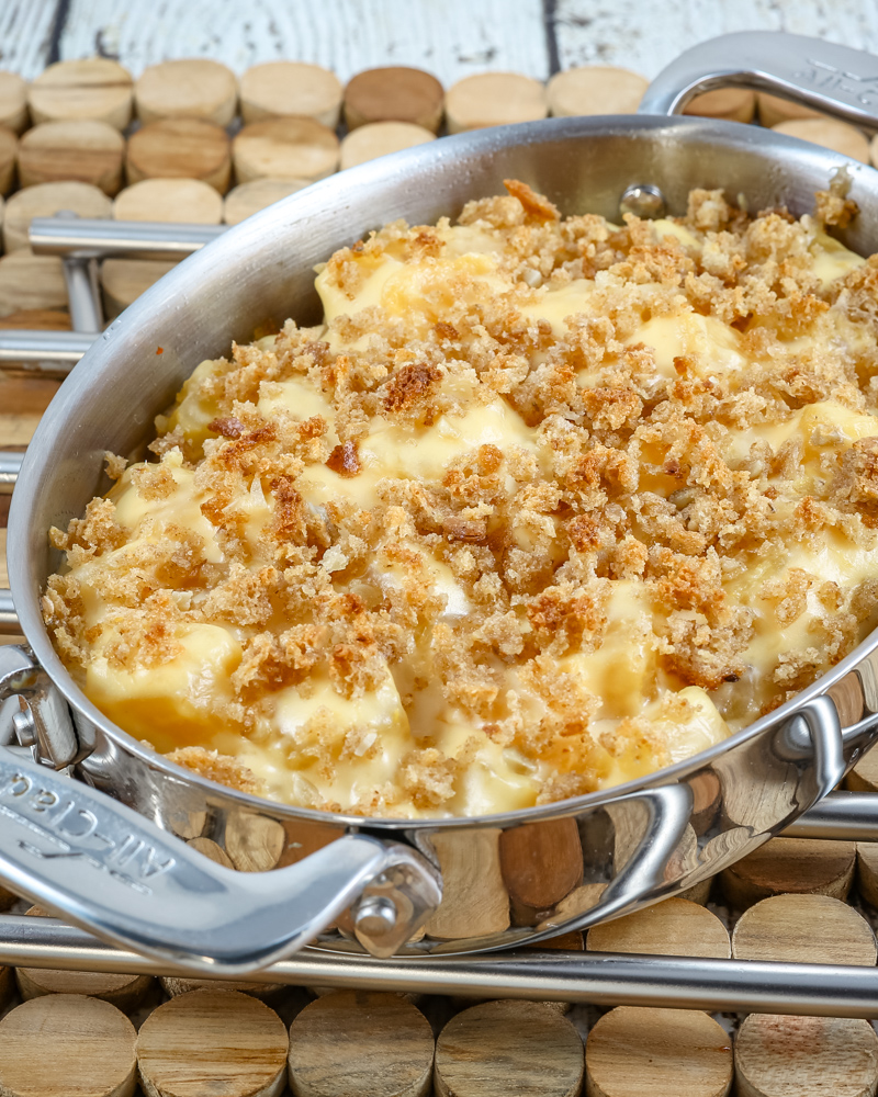 A baking dish with rutabaga gratin with breadcrumb topping and cheese.